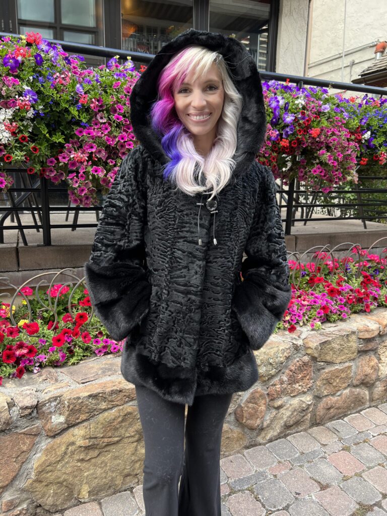 Our hooded dyed black Persian lamb jacket with dyed black mink trim is elegant and cozy. This jacket is a timeless and stylish addition to any wardrobe.