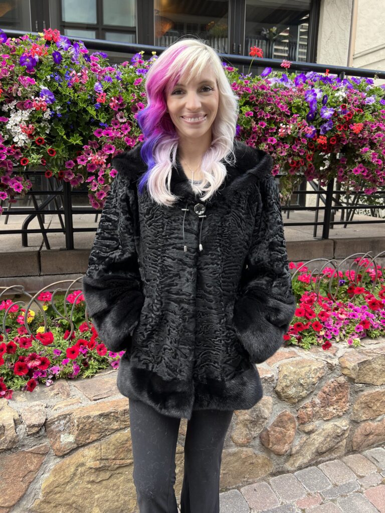 Our hooded dyed black Persian lamb jacket with dyed black mink trim is elegant and cozy. This jacket is a timeless and stylish addition to any wardrobe.