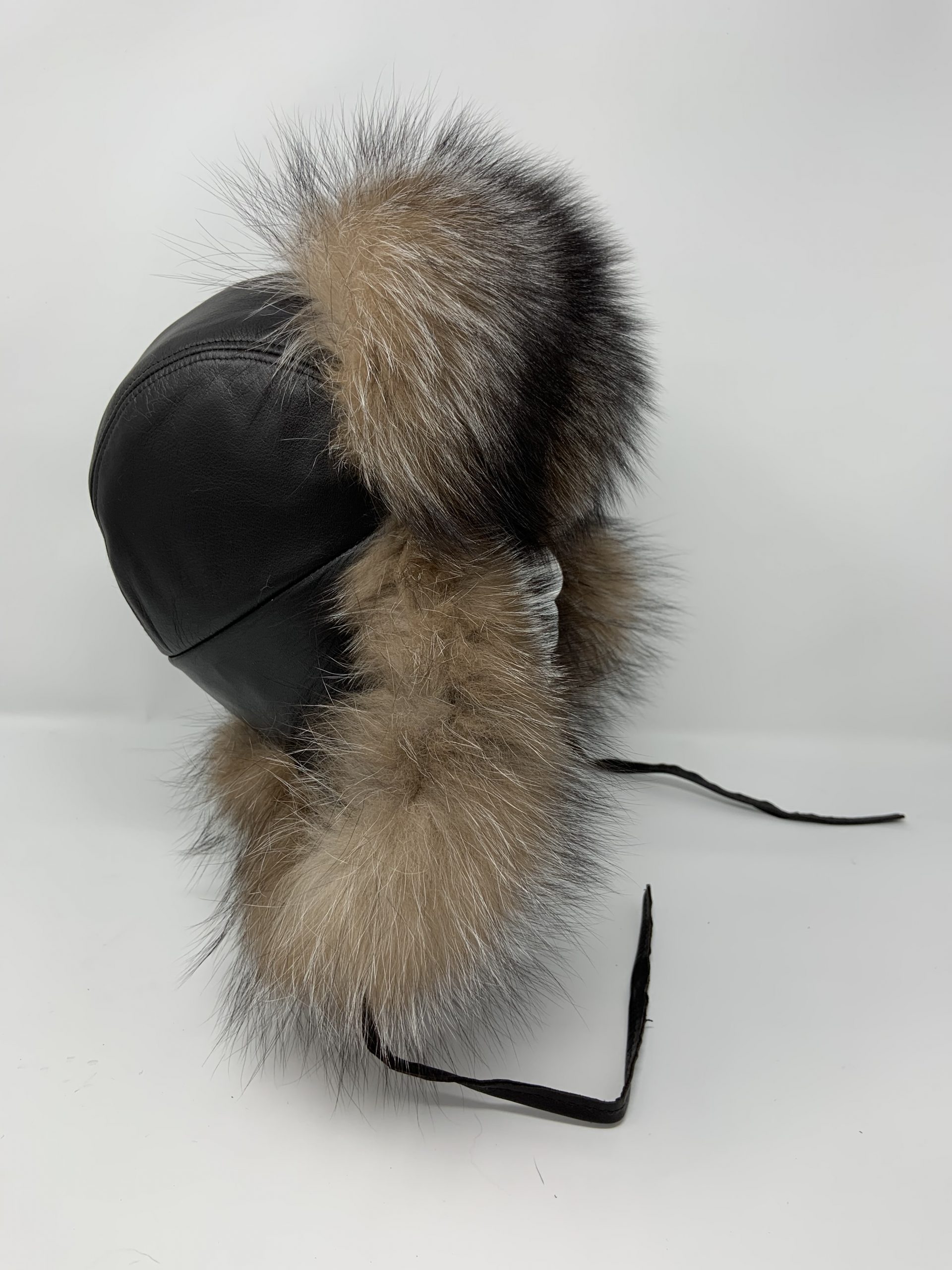 IMG_1747-scaled-1.jpg Our dark brown leather trapper with crystal fox trim combines classic style and essential warmth. Crafted from premium leather, it offers durability and a sleek look.