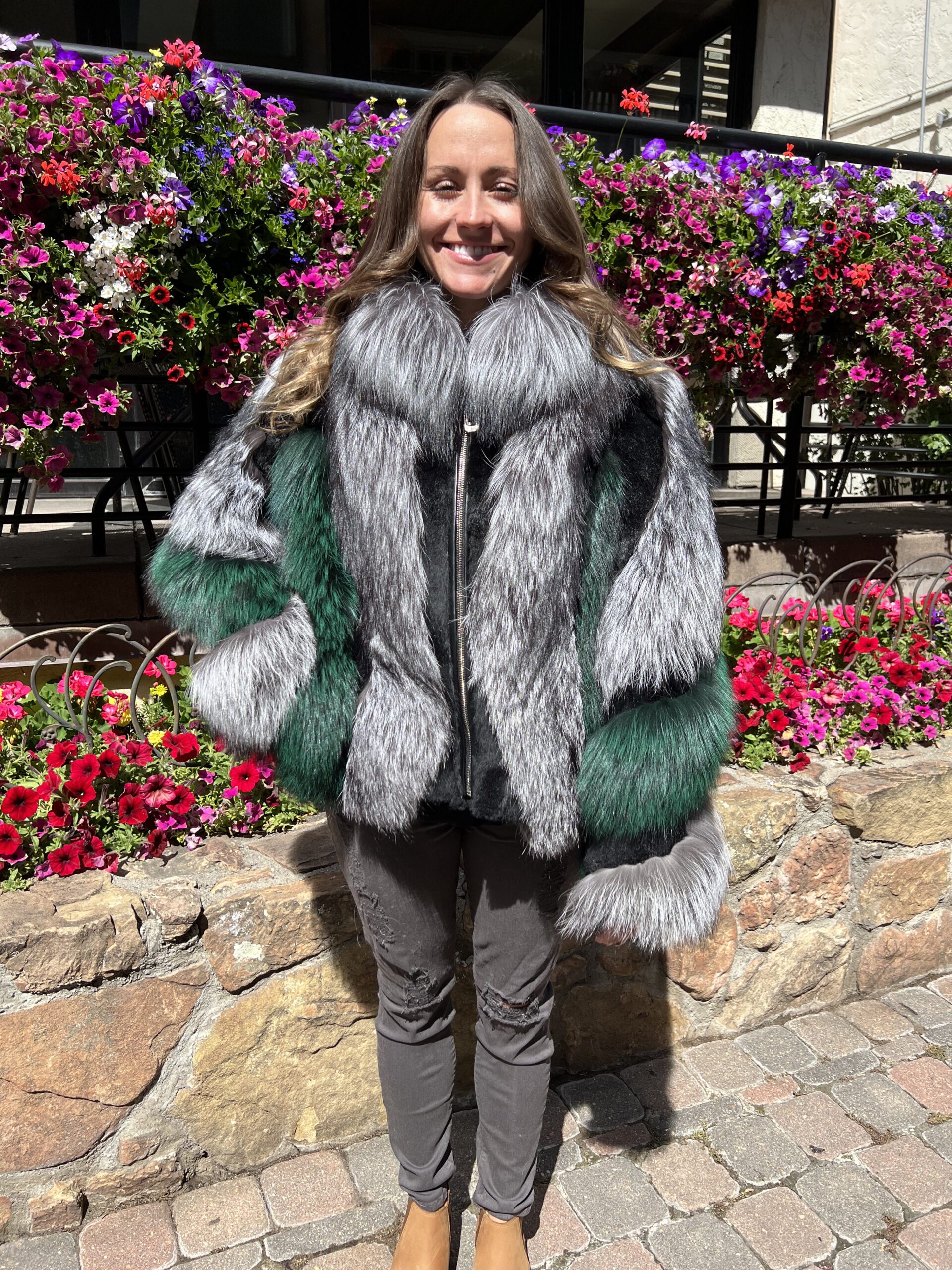 Our natural silver fox jacket with dyed green fox fur and black rabbit accents has a unique and stylish look. This jacket is perfect for those who seek a bold fashion statement without sacrificing warmth and comfort. Its blend of different furs makes it a versatile piece that can elevate any outfit.