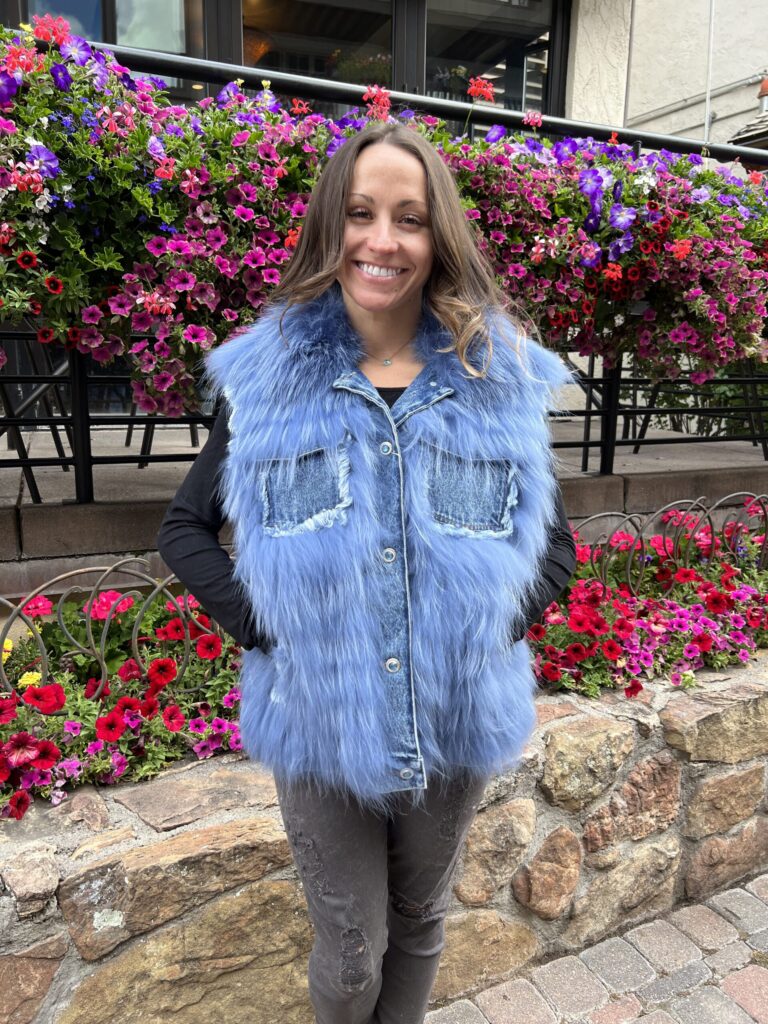 Blue Finn raccoon vest with a fluffy, textured design and denim accents by Fantasia Furs.