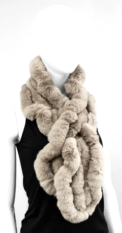 Our taupe rabbit fur scarf is a cozy and elegant accessory. It adds a touch of luxury to any winter wardrobe. Made from soft rabbit fur, it wraps you in warmth and comfort, perfect for chilly days.