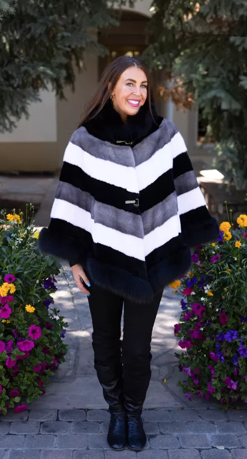 Our tri-color mink cape with fox trim combines sleek mink fur with soft fox trim. It offers a stylish and cozy layer, perfect for enhancing any outfit.