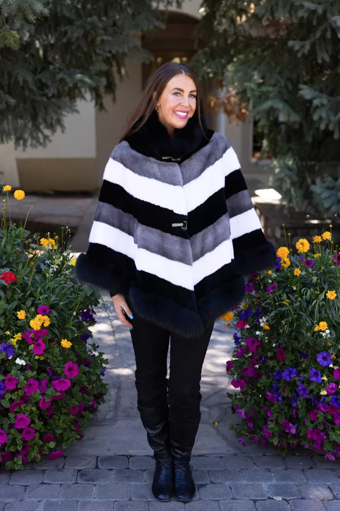 Our tri-color mink cape with fox trim combines sleek mink fur with soft fox trim. It offers a stylish and cozy layer, perfect for enhancing any outfit.