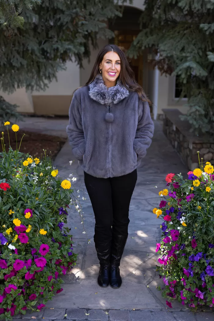 This dyed blue iris mink zip-up jacket with indigo fox trim blends rich color with soft luxury. The blue mink creates a sleek base, while the indigo fox trim adds texture and warmth. This jacket enhances your style with elegance and keeps you cozy on colder days.