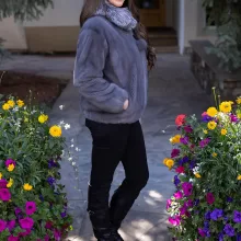 This dyed blue iris mink zip-up jacket with indigo fox trim blends rich color with soft luxury. The blue mink creates a sleek base, while the indigo fox trim adds texture and warmth. This jacket enhances your style with elegance and keeps you cozy on colder days.