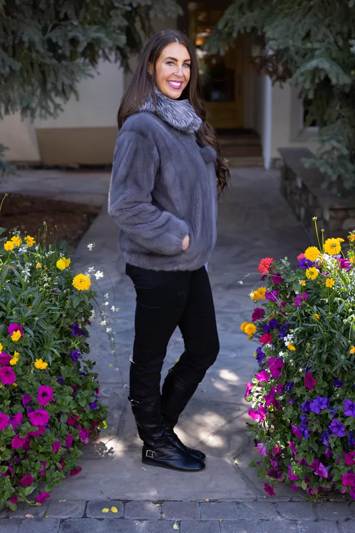 This dyed blue iris mink zip-up jacket with indigo fox trim blends rich color with soft luxury. The blue mink creates a sleek base, while the indigo fox trim adds texture and warmth. This jacket enhances your style with elegance and keeps you cozy on colder days.