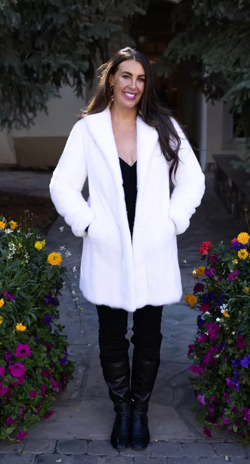 Our dyed white mink jacket combines elegance with cozy warmth. The pristine white fur enhances any outfit beautifully. Its soft texture provides comfort for any occasion.