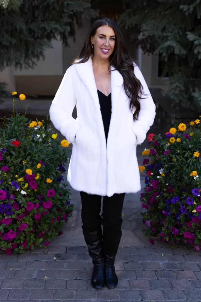 Our dyed white mink jacket combines elegance with cozy warmth. The pristine white fur enhances any outfit beautifully. Its soft texture provides comfort for any occasion.