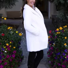 Our dyed white mink jacket combines elegance with cozy warmth. The pristine white fur enhances any outfit beautifully. Its soft texture provides comfort for any occasion.