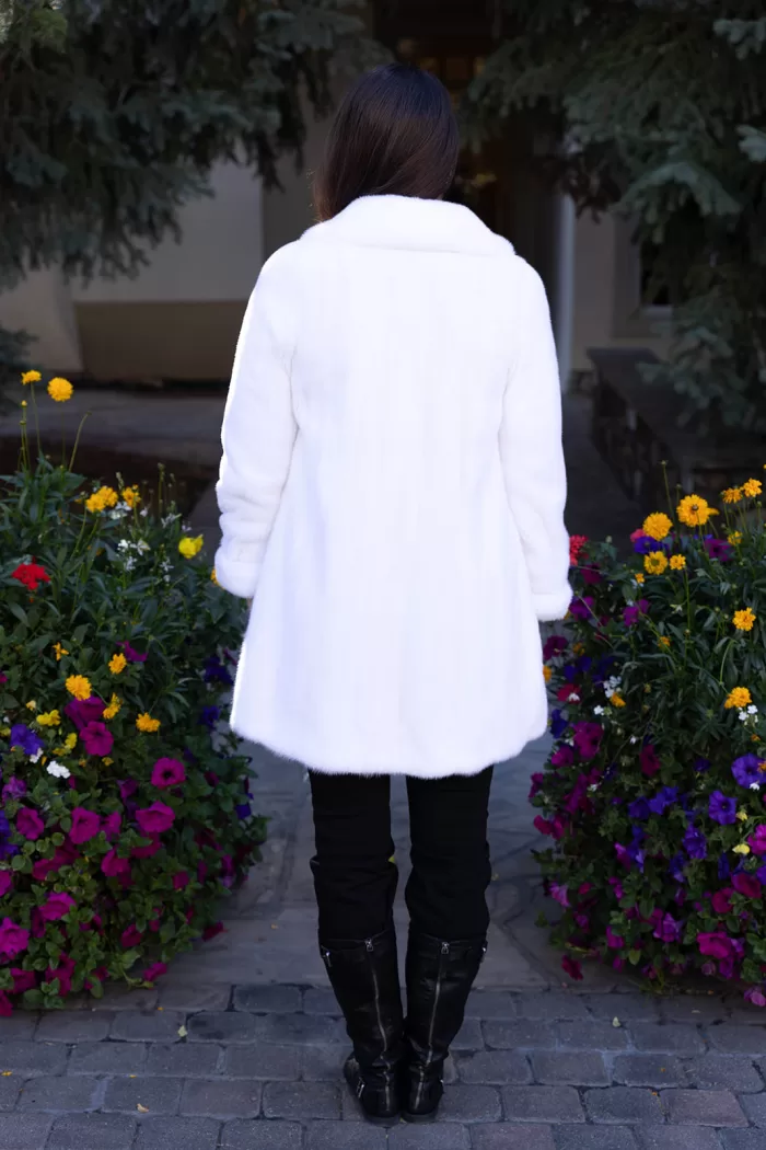 Our dyed white mink jacket combines elegance with cozy warmth. The pristine white fur enhances any outfit beautifully. Its soft texture provides comfort for any occasion.