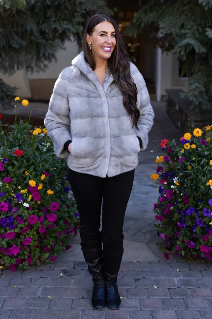 This sapphire mink jacket with a hood offers a sleek, classic look. The hood provides added warmth and comfort for any occasion.