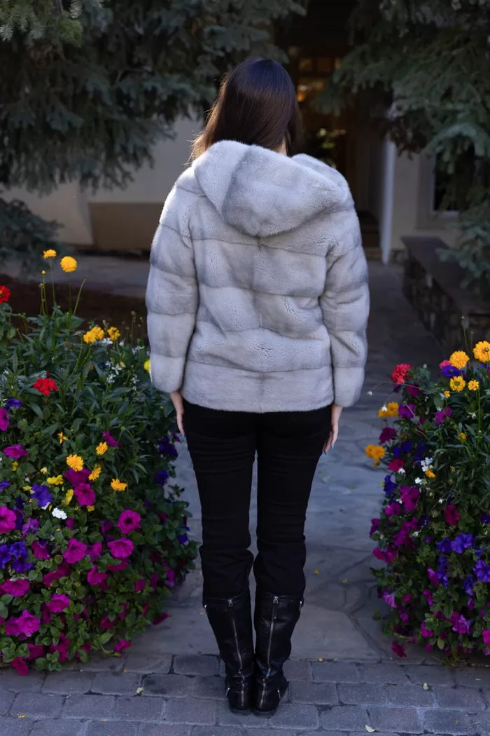 This sapphire mink jacket with a hood offers a sleek, classic look. The hood provides added warmth and comfort for any occasion.