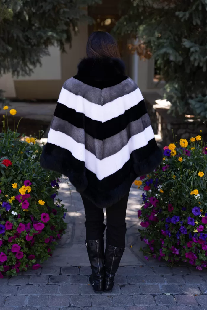 Our tri-color mink cape with fox trim combines sleek mink fur with soft fox trim. It offers a stylish and cozy layer, perfect for enhancing any outfit.