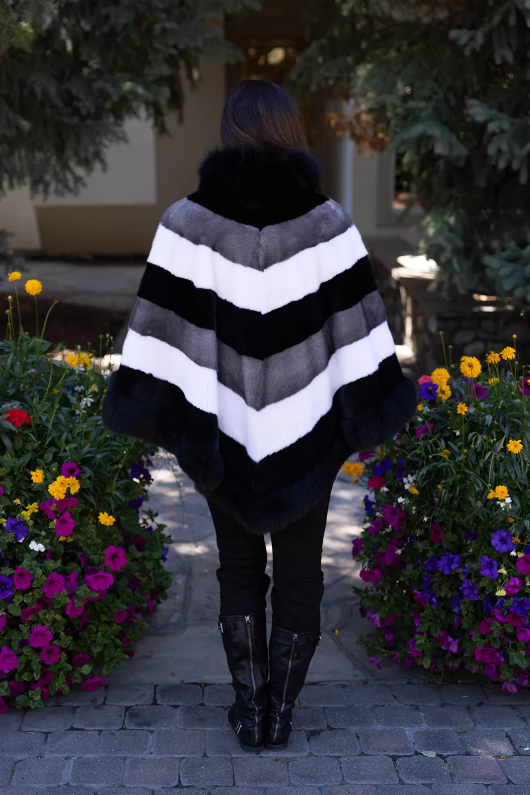Fantasia Furs Our tri-color mink cape with fox trim combines sleek mink fur with soft fox trim. It offers a stylish and cozy layer, perfect for enhancing any outfit.