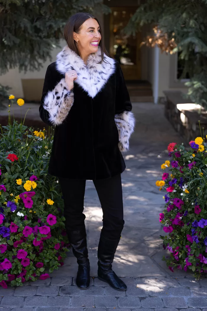 Our black sheared mink jacket with a natural lynx collar and cuffs combines sleek style with luxurious details. The soft black mink creates a smooth, elegant look, while the natural lynx adds texture and striking contrast. This jacket keeps you warm and stylish, making it a perfect choice for any winter occasion.