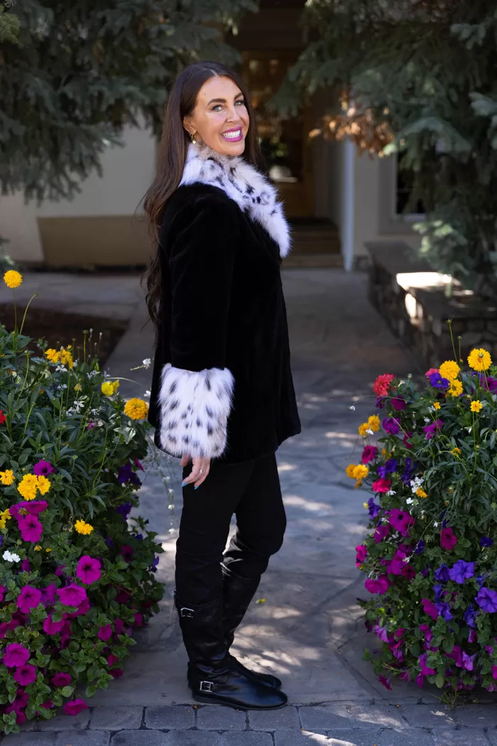 Our black sheared mink jacket with a natural lynx collar and cuffs combines sleek style with luxurious details. The soft black mink creates a smooth, elegant look, while the natural lynx adds texture and striking contrast. This jacket keeps you warm and stylish, making it a perfect choice for any winter occasion.