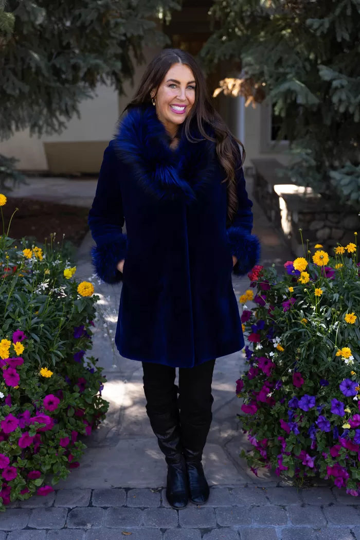 This dyed blue sheared mink stroller features a dyed blue silver fox collar and cuffs. Together, they offer bold style and cozy warmth. The sleek...