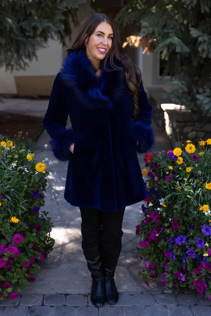 This dyed blue sheared mink stroller features a dyed blue silver fox collar and cuffs. Together, they offer bold style and cozy warmth. The sleek...