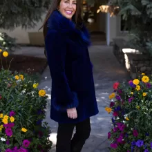 This dyed blue sheared mink stroller features a dyed blue silver fox collar and cuffs. Together, they offer bold style and cozy warmth. The sleek...