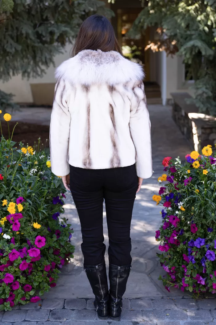 This natural sapphire cross mink jacket with platinum fox trim offers elegance and warmth. The mink’s unique pattern pairs beautifully with the soft platinum fox trim. Additionally, its luxurious design adds a refined touch to any outfit.