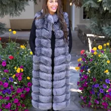 Natural Silver Fox Duster Vest brings luxurious style and warmth to any outfit. The soft silver fox fur showcases its natural blend of gray, black, and white tones, creating a stunning visual effect. The long duster design adds elegance, making it a perfect statement piece for any occasion.