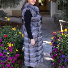 Natural Silver Fox Duster Vest brings luxurious style and warmth to any outfit. The soft silver fox fur showcases its natural blend of gray, black, and white tones, creating a stunning visual effect. The long duster design adds elegance, making it a perfect statement piece for any occasion.