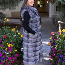 Natural Silver Fox Duster Vest brings luxurious style and warmth to any outfit. The soft silver fox fur showcases its natural blend of gray, black, and white tones, creating a stunning visual effect. The long duster design adds elegance, making it a perfect statement piece for any occasion.