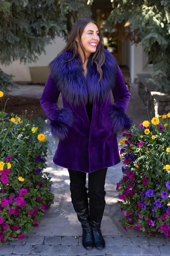 Our dyed purple sheared mink stroller with dyed purple silver fox combines bold color with luxury. Moreover, the soft mink offers warmth and elegance. The silver fox trim adds texture and a striking contrast. This stroller creates a stylish and vibrant look for any occasion.