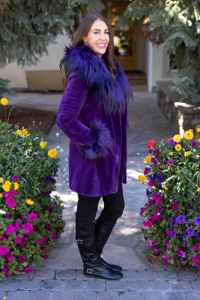 Our dyed purple sheared mink stroller with dyed purple silver fox combines bold color with luxury. Moreover, the soft mink offers warmth and elegance. The silver fox trim adds texture and a striking contrast. This stroller creates a stylish and vibrant look for any occasion.