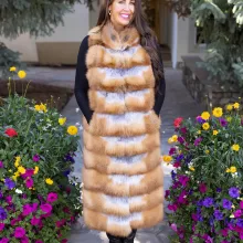 This natural red fox duster vest adds bold style and warmth to any outfit. The vibrant red fox fur creates a striking look, while the long duster design...