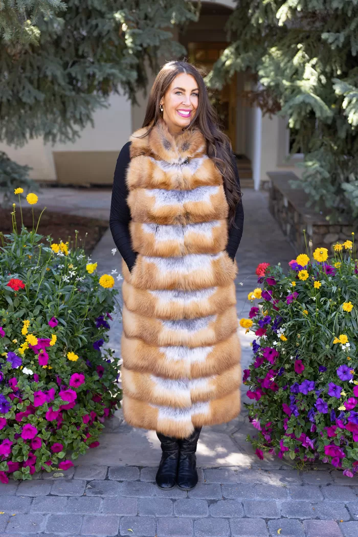 This natural red fox duster vest adds bold style and warmth to any outfit. The vibrant red fox fur creates a striking look, while the long duster design...