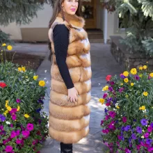 This natural red fox duster vest adds bold style and warmth to any outfit. The vibrant red fox fur creates a striking look, while the long duster design...