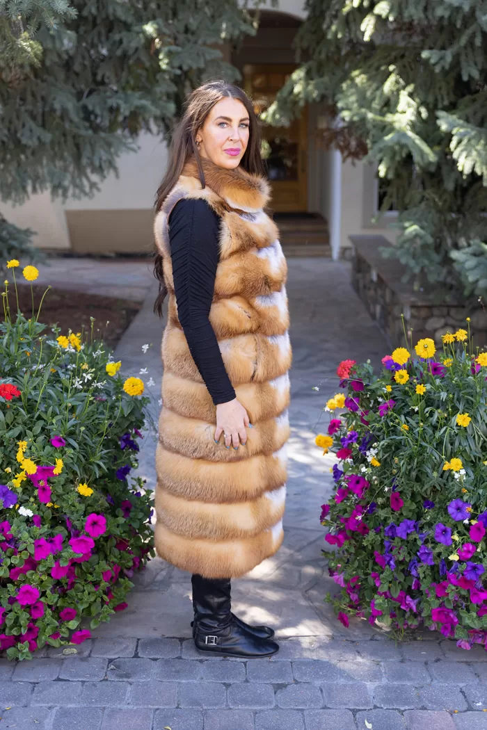 This natural red fox duster vest adds bold style and warmth to any outfit. The vibrant red fox fur creates a striking look, while the long duster design...