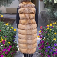 This natural red fox duster vest adds bold style and warmth to any outfit. The vibrant red fox fur creates a striking look, while the long duster design...