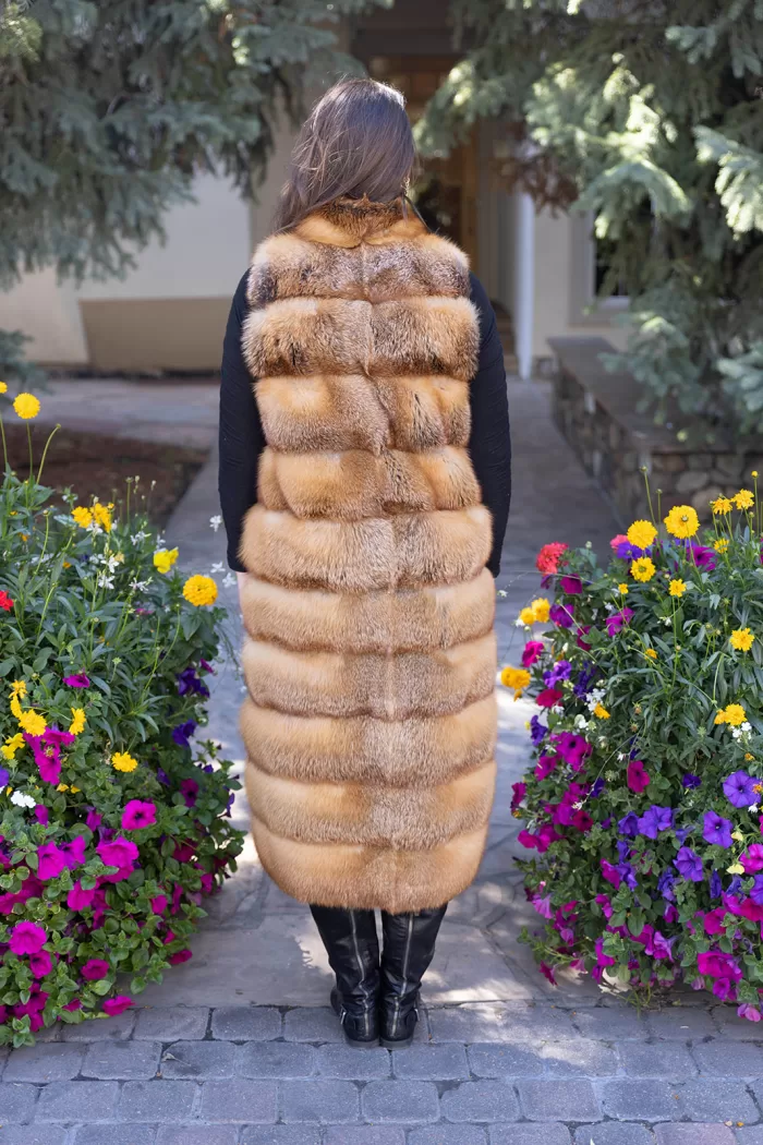 This natural red fox duster vest adds bold style and warmth to any outfit. The vibrant red fox fur creates a striking look, while the long duster design...