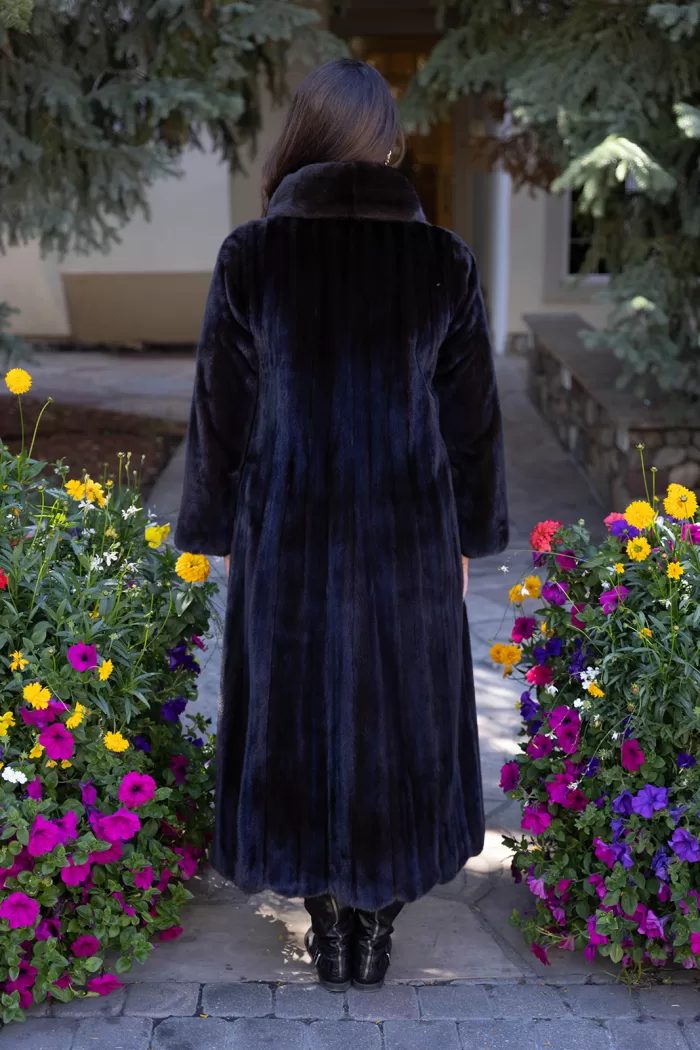 This dyed black ranch mink coat showcases sleek style and warmth. The rich black fur adds elegance to any outfit. Additionally, its soft texture ensures comfort for all occasions.