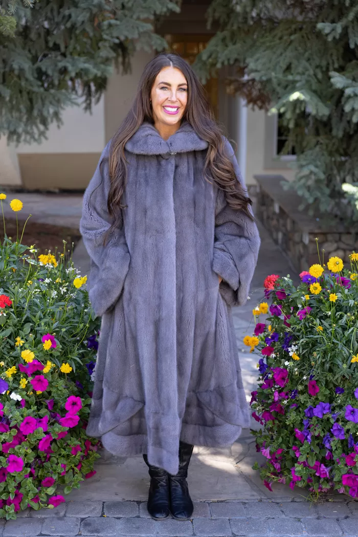 Our dyed blue iris mink swing coat adds elegance and movement to your wardrobe. The rich blue iris mink creates a luxurious look, while the swing design offers a graceful silhouette. This coat keeps you warm and stylish, making it a perfect choice for any occasion.