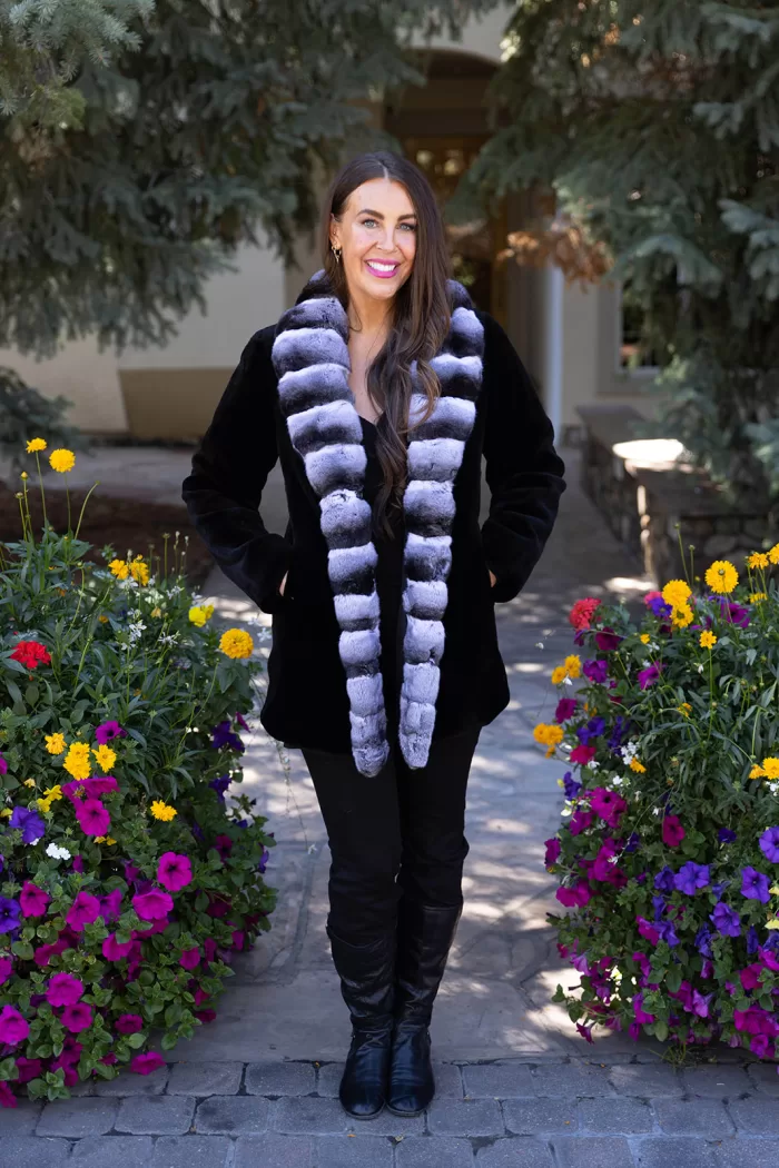 Our black reversible sheared mink coat with chinchilla trim combines luxury and versatility. The sheared mink offers softness and elegance. The chinchilla trim adds texture and sophistication. Its reversible design lets you switch styles effortlessly. This coat keeps you warm while enhancing your look for any occasion.