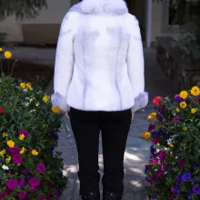 This natural sapphire cross mink jacket with platinum fox trim showcases luxurious style and warmth. The sapphire cross mink fur creates a stunning pattern, while the platinum fox trim adds a soft, elegant contrast. This jacket elevates any outfit, making it a perfect choice for those seeking sophistication and comfort.