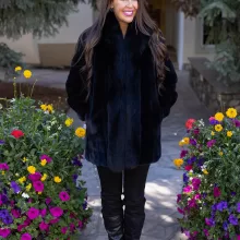 Our black reversible mink coat with fox tuxedo trim combines luxury and practicality. On one side, the sleek black mink fur offers warmth and elegance. While on the other side, the reversible design provides a versatile alternative. The fox tuxedo trim adds a bold and refined touch. As a result, this coat becomes a stylish choice for any occasion.