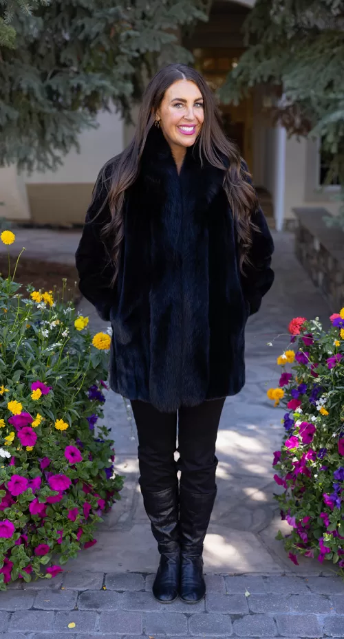 Our black reversible mink coat with fox tuxedo trim combines luxury and practicality. On one side, the sleek black mink fur offers warmth and elegance. While on the other side, the reversible design provides a versatile alternative. The fox tuxedo trim adds a bold and refined touch. As a result, this coat becomes a stylish choice for any occasion.