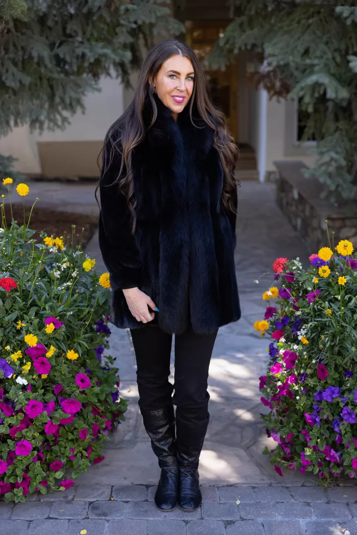 Our black reversible mink coat with fox tuxedo trim combines luxury and practicality. On one side, the sleek black mink fur offers warmth and elegance. While on the other side, the reversible design provides a versatile alternative. The fox tuxedo trim adds a bold and refined touch. As a result, this coat becomes a stylish choice for any occasion.