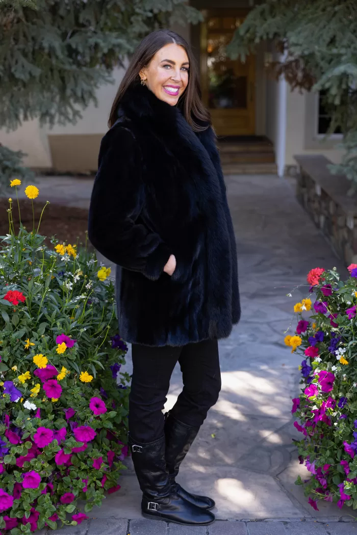 Our black reversible mink coat with fox tuxedo trim combines luxury and practicality. On one side, the sleek black mink fur offers warmth and elegance. While on the other side, the reversible design provides a versatile alternative. The fox tuxedo trim adds a bold and refined touch. As a result, this coat becomes a stylish choice for any occasion.