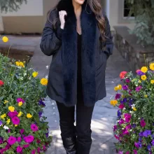 Our black reversible mink coat with fox tuxedo trim combines luxury and practicality. On one side, the sleek black mink fur offers warmth and elegance. While on the other side, the reversible design provides a versatile alternative. The fox tuxedo trim adds a bold and refined touch. As a result, this coat becomes a stylish choice for any occasion.