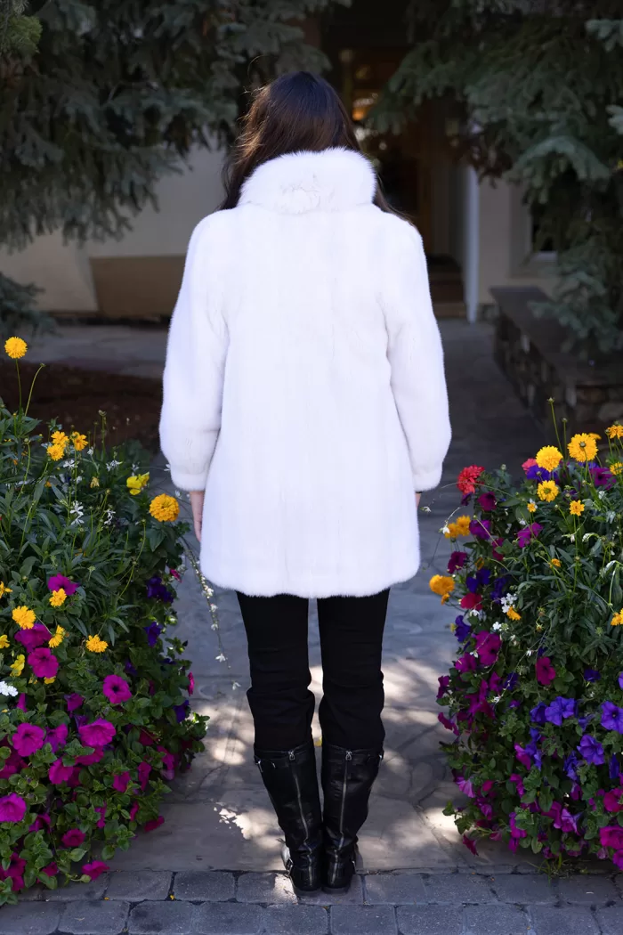 This white reversible mink coat with fox trim combines style and adaptability. The reversible design lets you switch between looks effortlessly. The soft white mink fur radiates elegance and warmth. The fox trim adds a touch of sophistication. As a result, this coat becomes a perfect choice for any occasion.