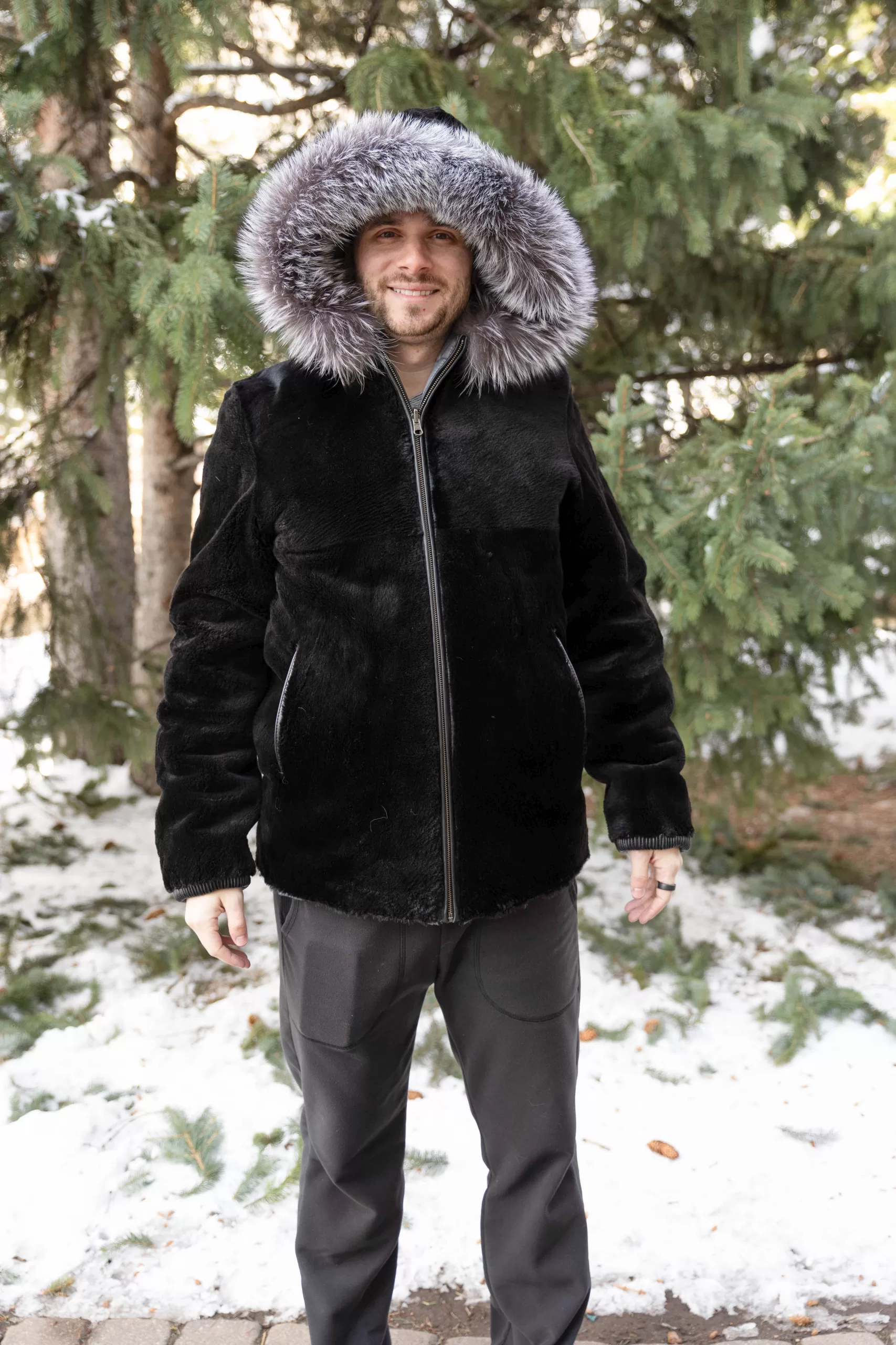 This hooded black reversible sheared beaver jacket with silver fox trim delivers modern style and versatility for any occasion. The plush black sheared beaver creates a sleek, refined look. Meanwhile, the silver fox trim adds a striking, luxurious accent. You will look sharp and confident every time you wear it.