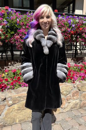 This dyed black sheared mink coat with natural chinchilla trim is beautiful and timeless. It is perfect for special occasions or adding a touch of...