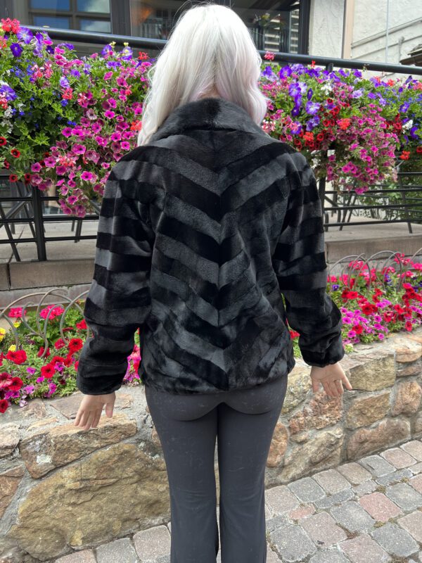Our zip-up dyed black sheared ranch mink jacket combines luxury with simplicity. This jacket has a sleek look and a comfortable fit, suitable for both...