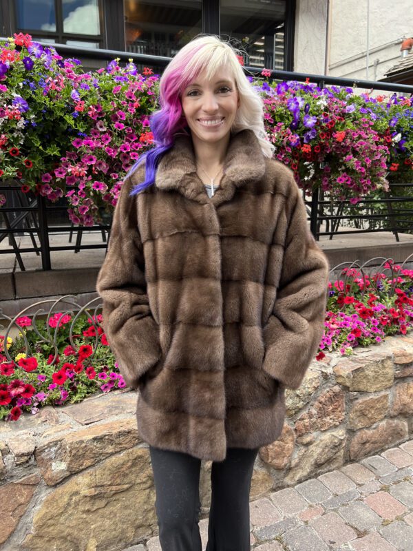 Our natural demi-buff mink jacket boasts a rich, deep brown shade with subtle lighter highlights. It has a warm and sophisticated look.